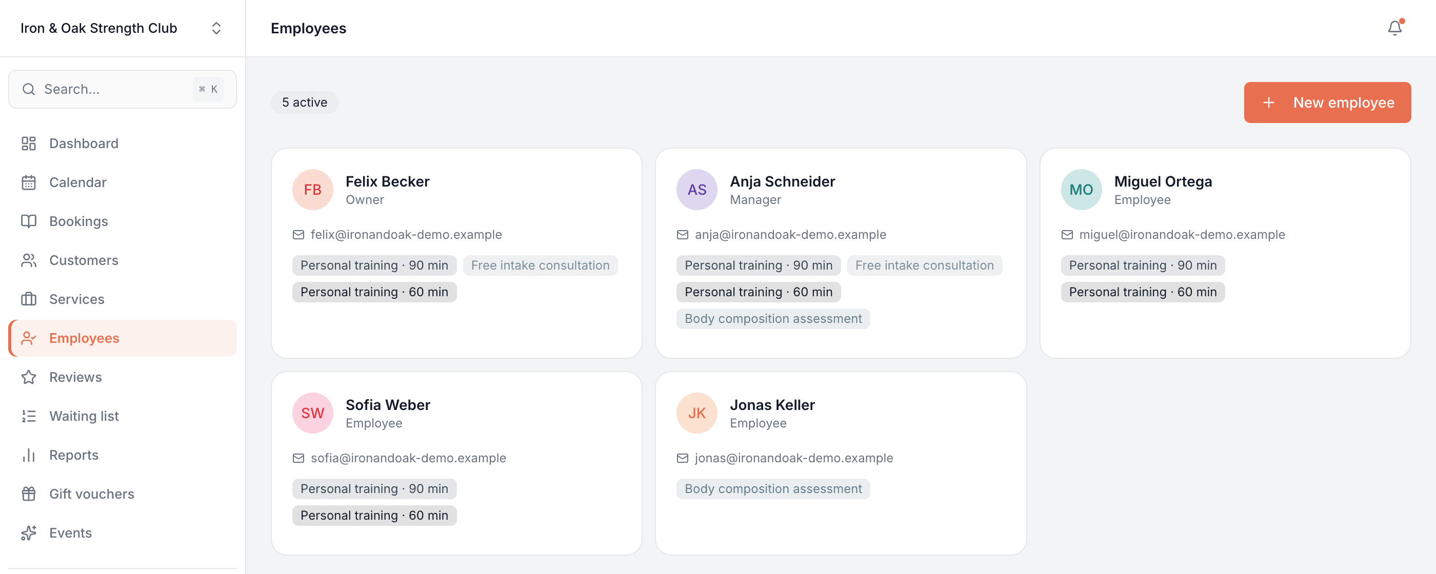 Employees screen showing team members as cards with their role, email and the services each one is assigned to
